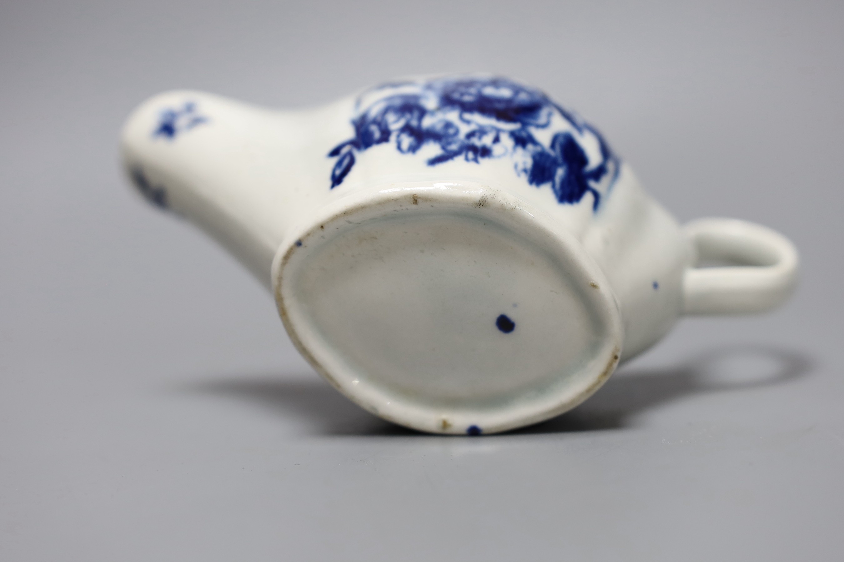 A Liverpool sauceboat decorated in blue underglaze flowers, the interior with further flowers and a dot and loop border, 16cm long